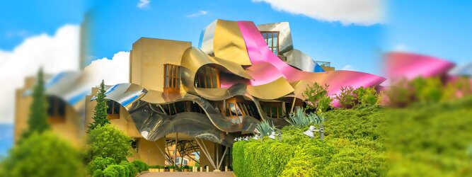 Reisetipps - Marqués de Riscal Design Hotel, Bilbao, Elciego, Spanien. Fantastisch galaktisch, unverkennbar ein Werk von Frank O. Gehry. Inmitten idyllischer Weinberge in der Rioja Region des Baskenlandes, bezaubert das schimmernde Bauobjekt mit einer Struktur bunter, edel glänzender verflochtener Metallbänder. Glanz im Baskenland - Es muss etwas ganz Besonderes sein. Emotional, zukunftsweisend, einzigartig. Denn in dieser Region, etwa 133 km südlich von Bilbao, sind Weingüter normalerweise nicht für die Öffentlichkeit zugänglich.